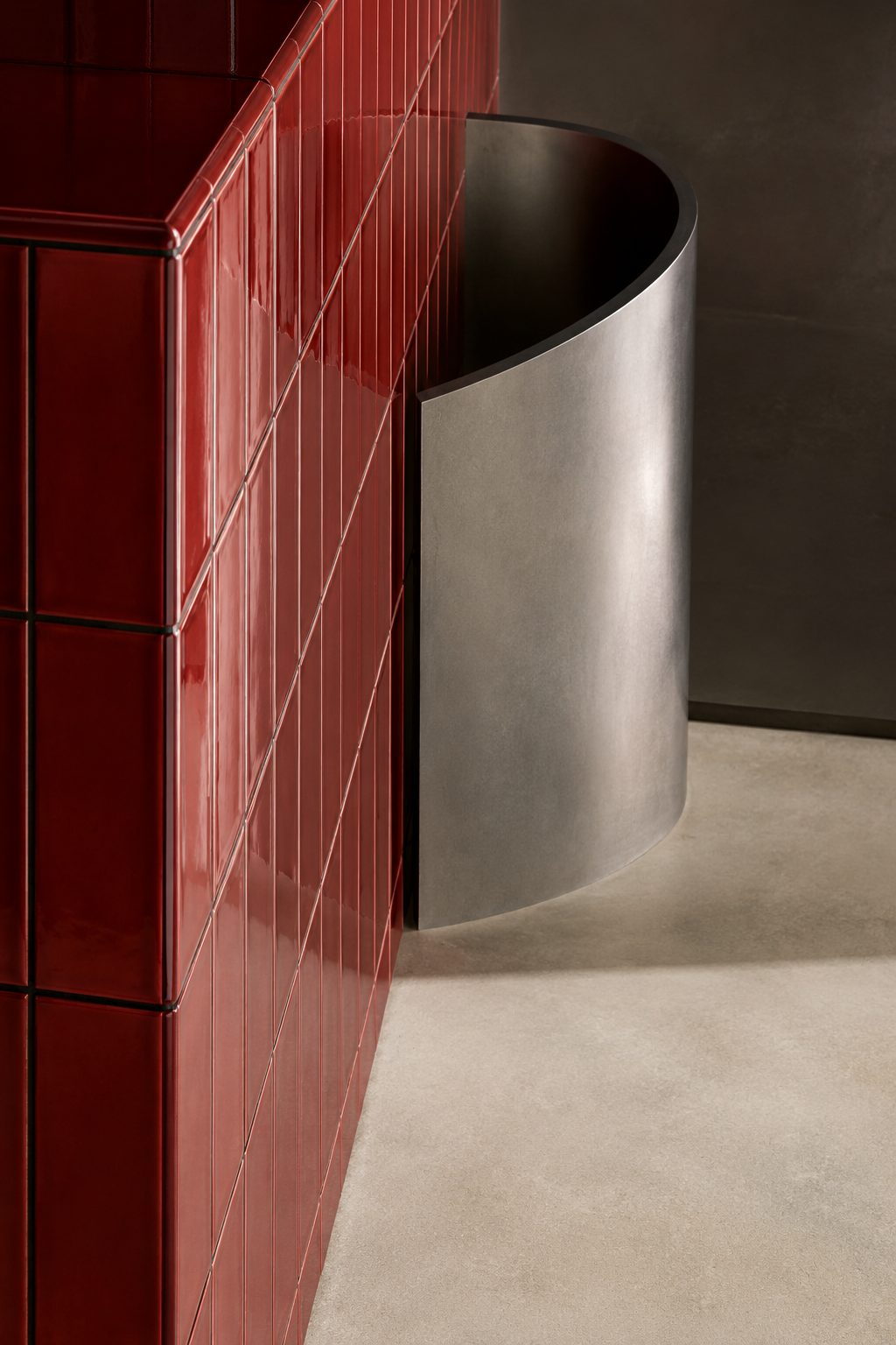 Concept render, red glazed tile against a steel curve