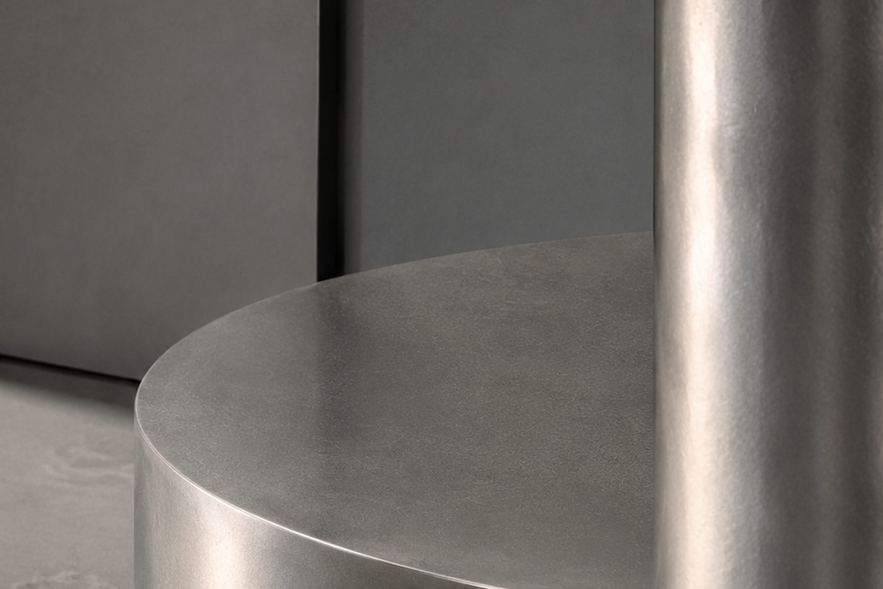 Concept render, a steel plinth against grey plaster in daylight