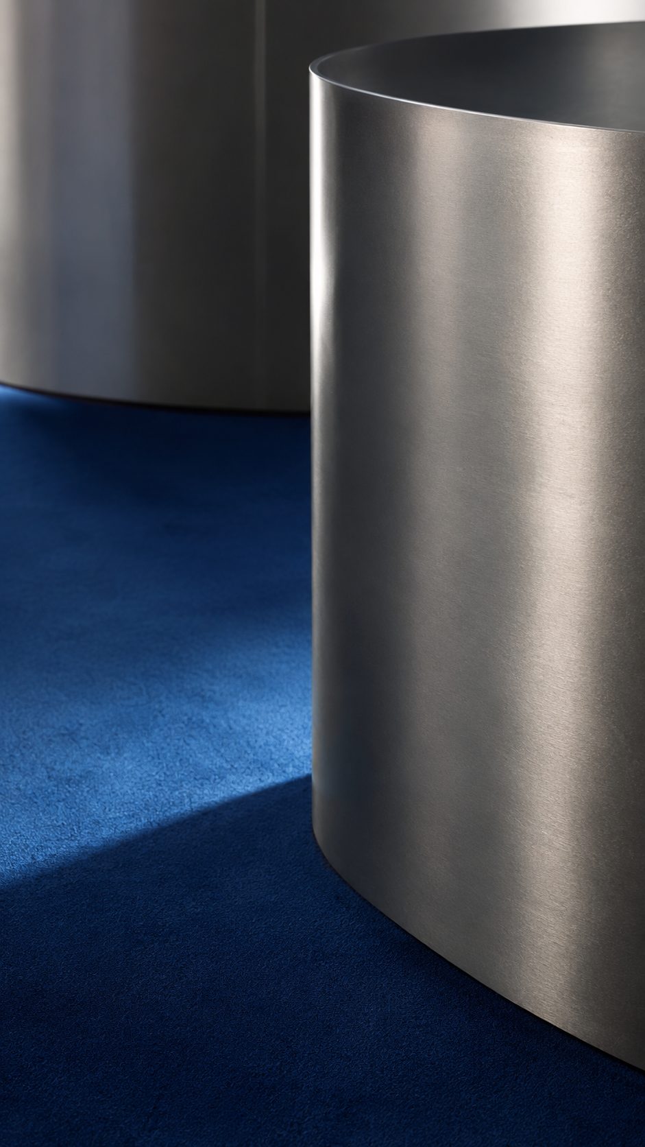 Concept render, a curved metal wall on a blue floor